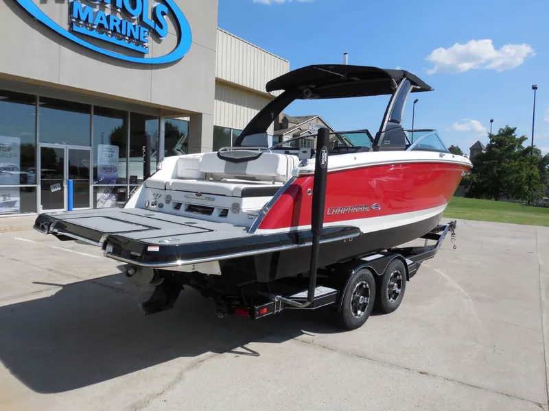 Slide: The Image of A red 2020 Chaparral 277 SSX boat on a trailer in front of a building. - 3