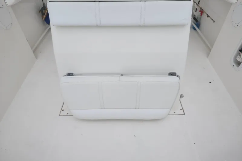 Slide: The Image of 2007 Edgewater 228CC boat interior with white cushioned seating. - 28