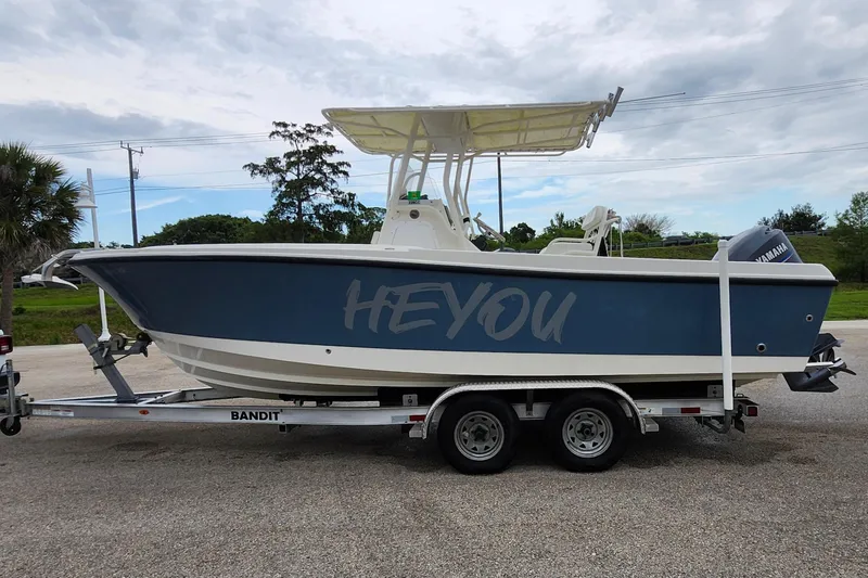 Slide: The Image of 2007 Edgewater 228CC boat on trailer, parked outdoors under cloudy sky. - 3