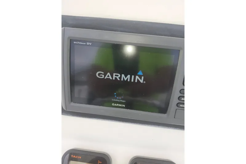 Slide: The Image of Garmin echomap DV on 2007 Edgewater 228CC boat dashboard, displaying loading maps screen. - 17