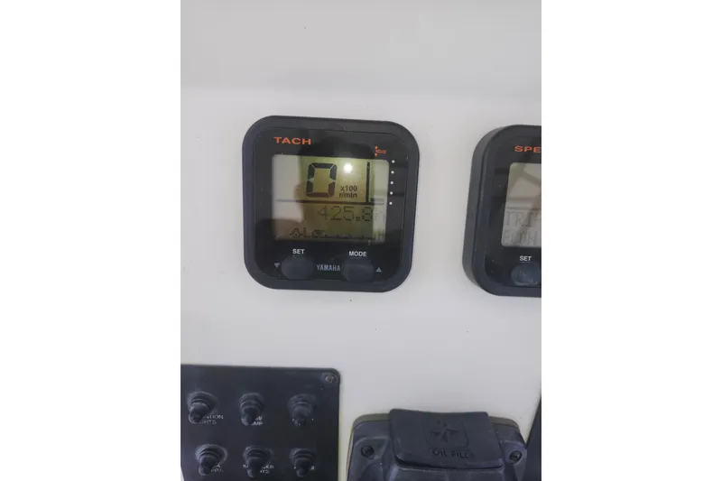 Slide: The Image of Dashboard of a 2007 Edgewater 228CC boat showing Yamaha tachometer and controls. - 18