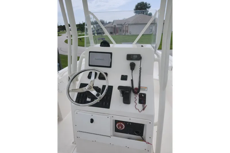 Slide: The Image of 2007 Edgewater 228CC boat console with steering wheel, Garmin display, and communication equipment. - 12
