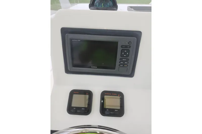 Slide: The Image of Dashboard of a 2007 Edgewater 228CC boat featuring Garmin and Yamaha displays. - 15