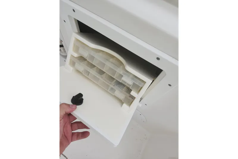 Slide: The Image of Storage compartment on a 2007 Edgewater 228CC boat, featuring organized trays. - 26