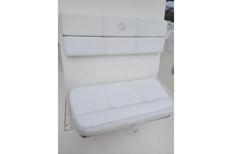 Slide: The Image of White cushioned seating on 2007 Edgewater 228CC boat, showcasing comfort and design. - 29