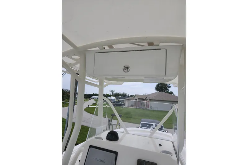 Slide: The Image of 2007 Edgewater 228CC boat console with Garmin navigation system and storage compartment. - 13