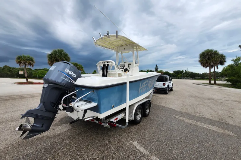 Slide: The Image of 2007 Edgewater 228CC boat on trailer with Yamaha engine, parked under cloudy sky. - 6
