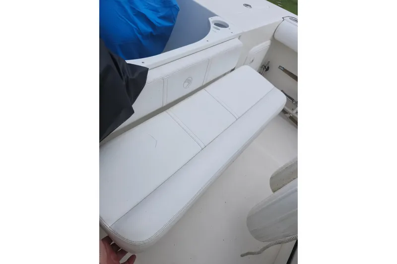Slide: The Image of White seating area on a 2007 Edgewater 228CC boat, featuring clean upholstery. - 31