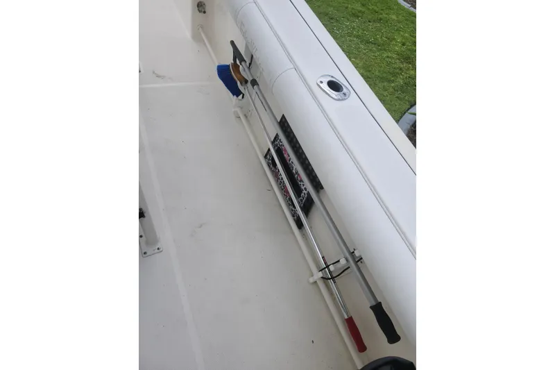 Slide: The Image of Edgewater 228CC 2007 boat interior with fishing rod holders and clean deck. - 36