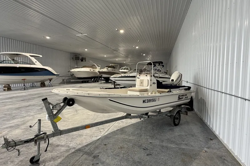 Slide: The Image of 2014 Carolina Skiff JV15CC boat on trailer in indoor storage facility. - 2