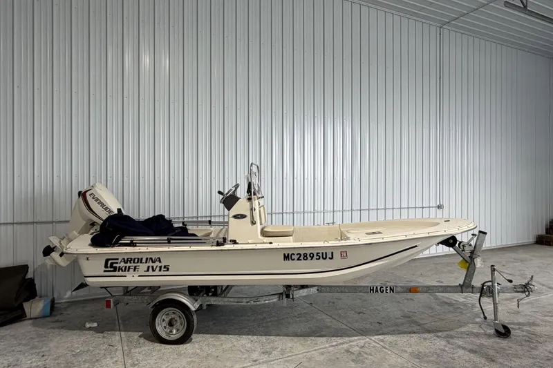 Slide: The Image of 2014 Carolina Skiff JV15CC boat on trailer in a garage setting. - 1