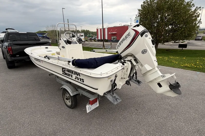 Slide: The Image of 2014 Carolina Skiff JV15CC boat on trailer with Evinrude outboard motor. - 9