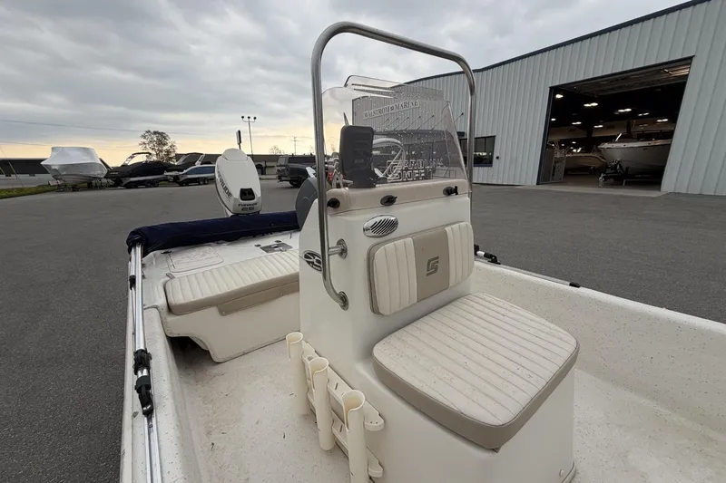 Slide: The Image of 2014 Carolina Skiff JV15CC boat with center console, parked near a marina. - 15