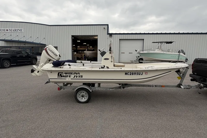 Slide: The Image of 2014 Carolina Skiff JV15CC boat on trailer, parked outside a marine dealership. - 7