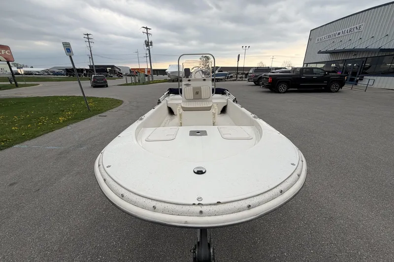 Slide: The Image of 2014 Carolina Skiff JV15CC boat parked at a marina with overcast skies. - 11