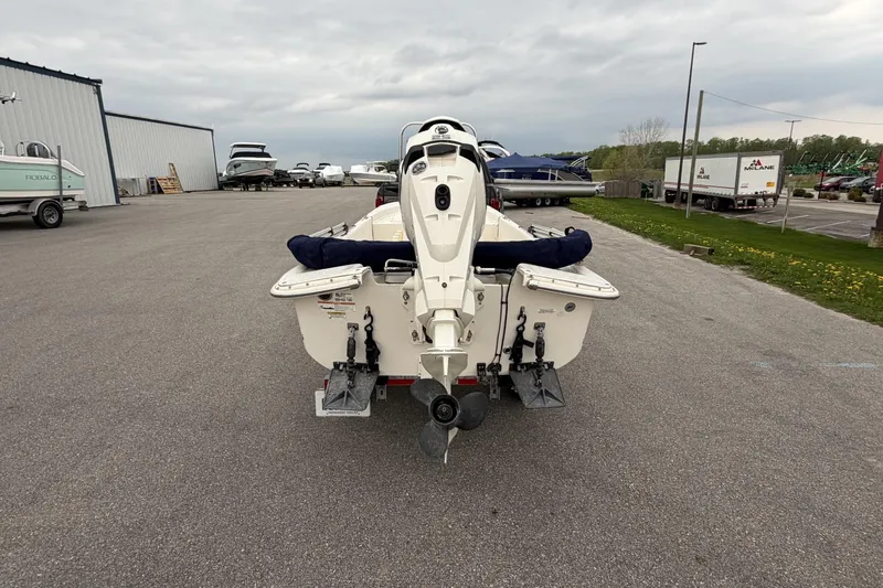 Slide: The Image of 2014 Carolina Skiff JV15CC boat rear view in a marina parking lot. - 10