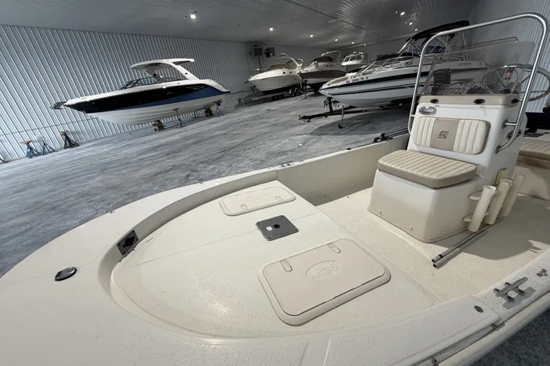 Slide: The Image of 2014 Carolina Skiff JV15CC boat in indoor storage with other vessels. - 3