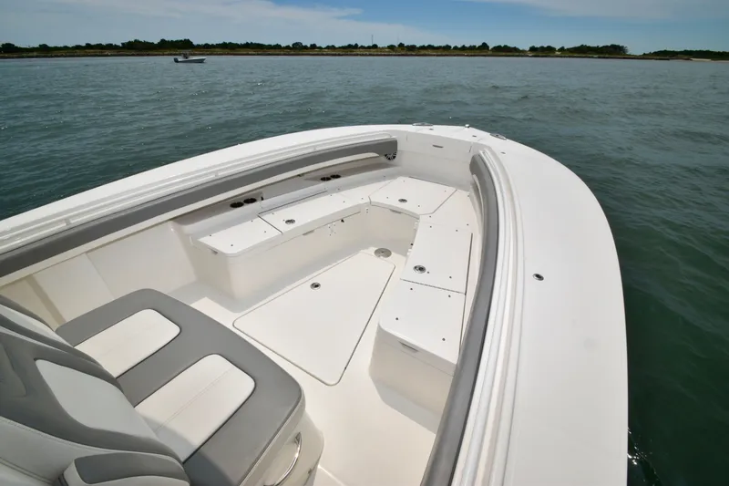 Slide: The Image of The image shows the bow of a 2023 Regulator 28 Forward Seating boat on the water. - 19