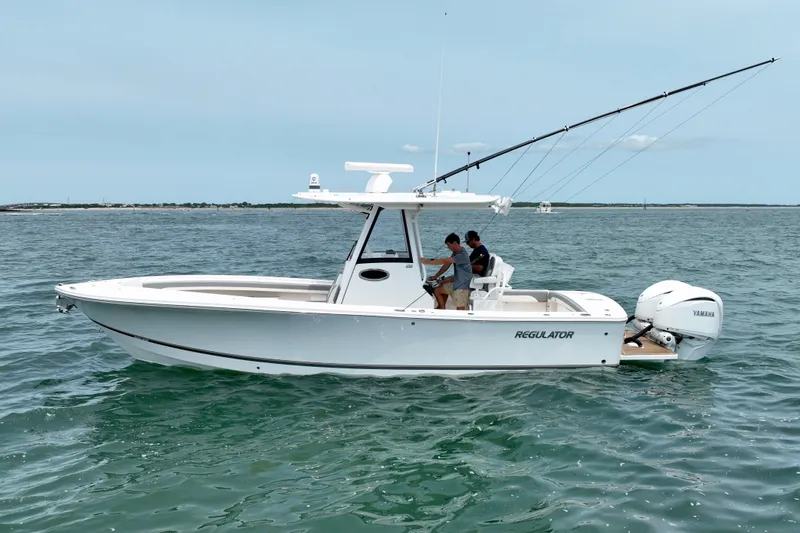 Slide: The Image of 2023 Regulator 28 Forward Seating on the water with two people on board. - 5