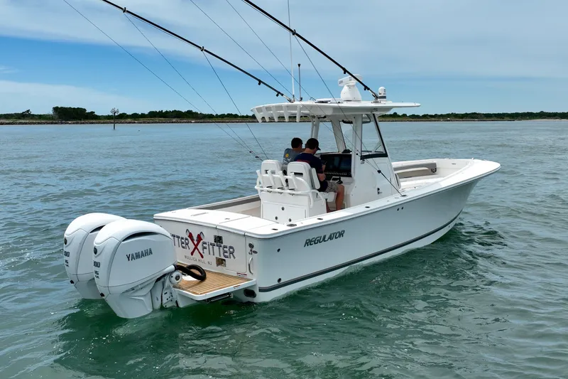 Slide: The Image of A white boat cruising on calm waters, featuring two outboard engines and a covered helm console. - 8