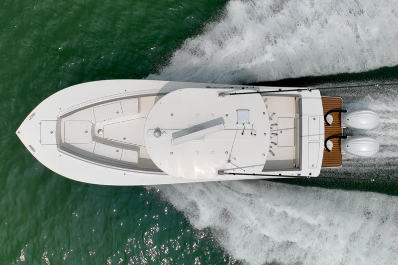 Slide: The Image of Aerial view of a 2023 Regulator 28 Forward Seating boat speeding across the water. - 17