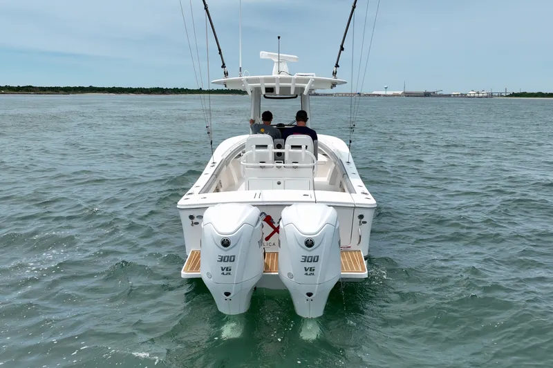 Slide: The Image of A 2023 Regulator 28 Forward Seating boat on the water with two outboard engines. - 7