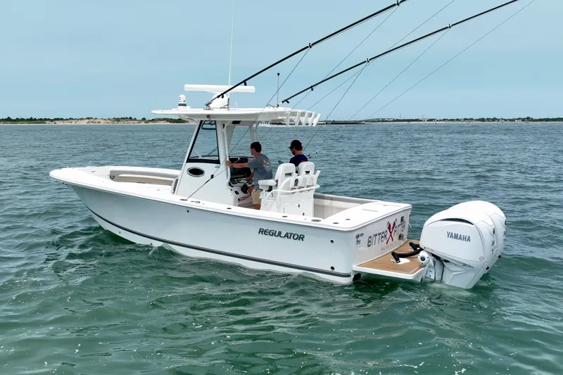 Slide: The Image of A white boat cruising on calm waters. It features two outboard engines and a covered helm console. - 6