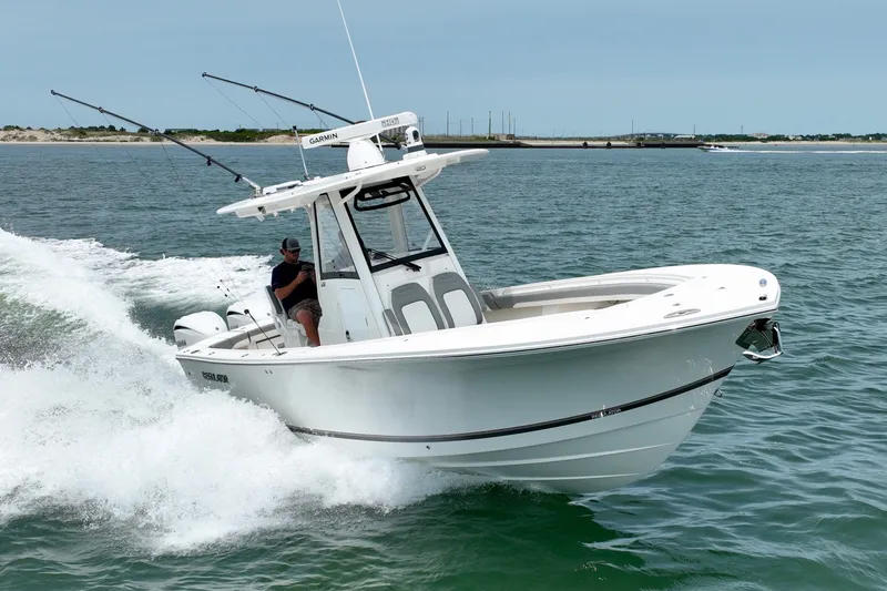 Slide: The Image of A white boat speeding across the water, with a driver on board and fishing rods visible. - 10
