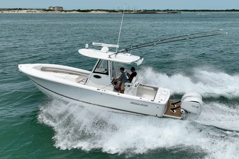 Slide: The Image of A white motorboat speeds across the water. Two people are on board. - 13