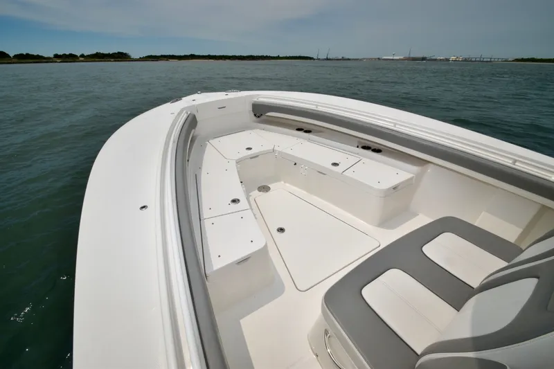 Slide: The Image of The image shows the bow of a 2023 Regulator 28 Forward Seating boat with gray upholstery. - 20