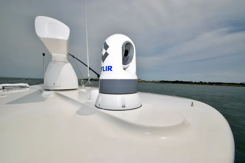 Slide: The Image of The image shows the deck of a 2023 Regulator 28 Forward Seating boat with a FLIR camera system. - 24