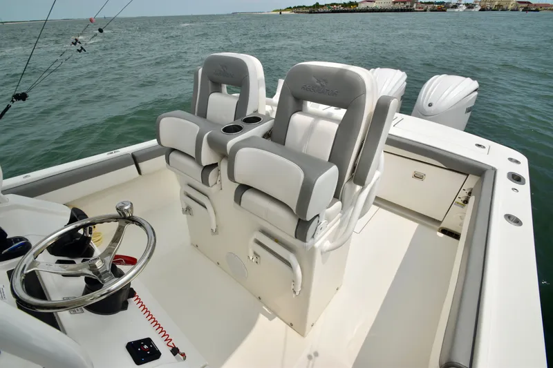 Slide: The Image of The image shows the cockpit of a 2023 Regulator 28 Forward Seating boat with two cushioned seats. - 35
