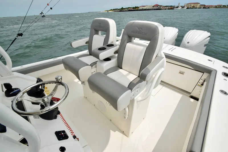 Slide: The Image of The image shows the cockpit of a 2023 Regulator 28 Forward Seating boat with two cushioned seats. - 36