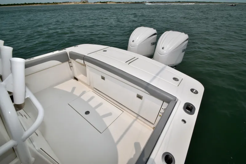 Slide: The Image of The image shows the stern of a 2023 Regulator 28 Forward Seating boat with twin outboard engines. - 44