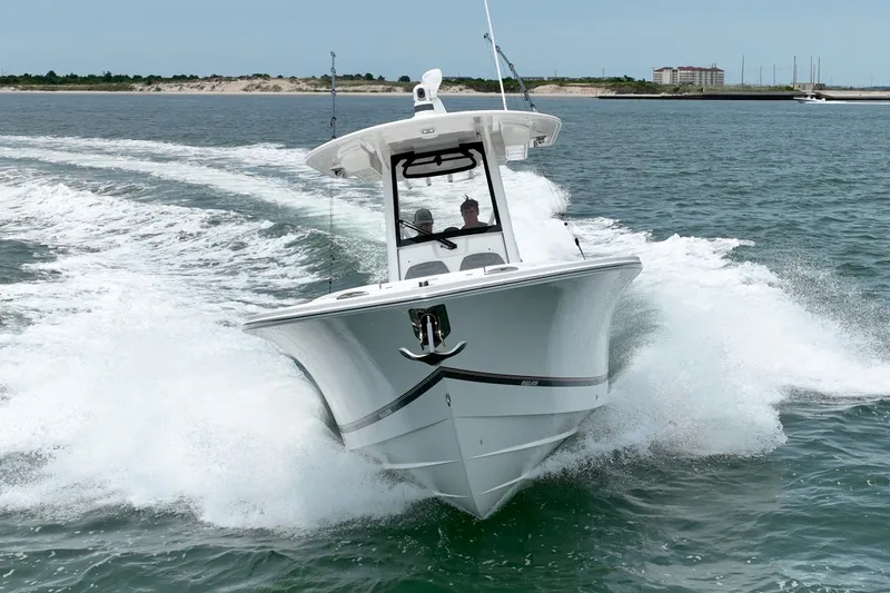Slide: The Image of A 2023 Regulator 28 Forward Seating boat speeds across the water, showing a clear bow view. - 12