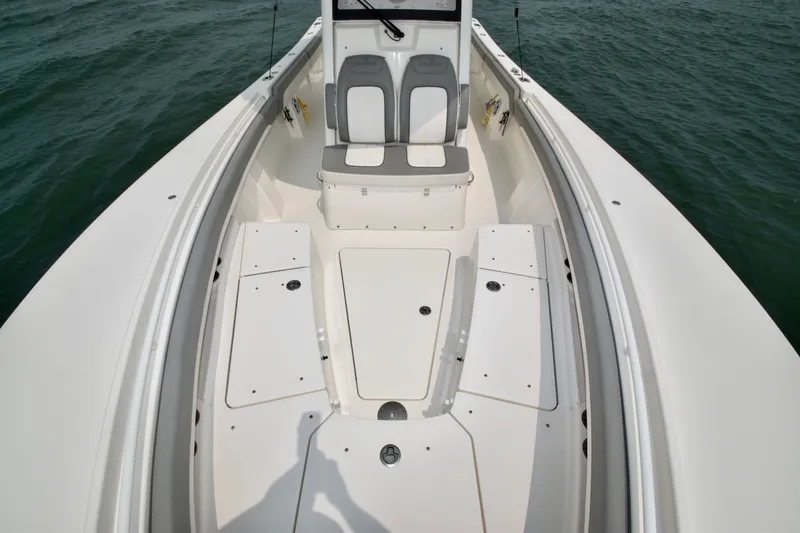 Slide: The Image of The image shows the bow of a 2023 Regulator 28 Forward Seating boat with gray seats. - 21