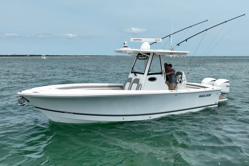 Slide: The Image of A white boat cruising on calm waters. It features a center console and twin outboard engines. - 4
