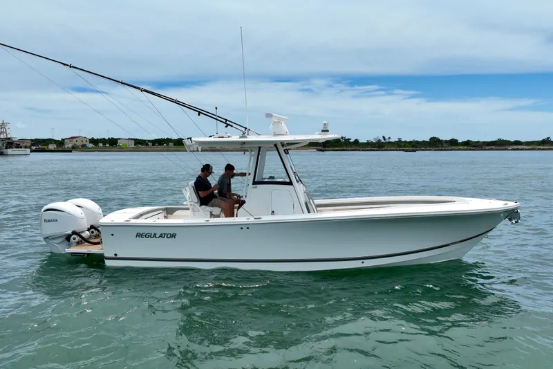 Slide: The Image of A white boat cruising on calm water with two people aboard. It features an open cabin and fishing rods. - 9
