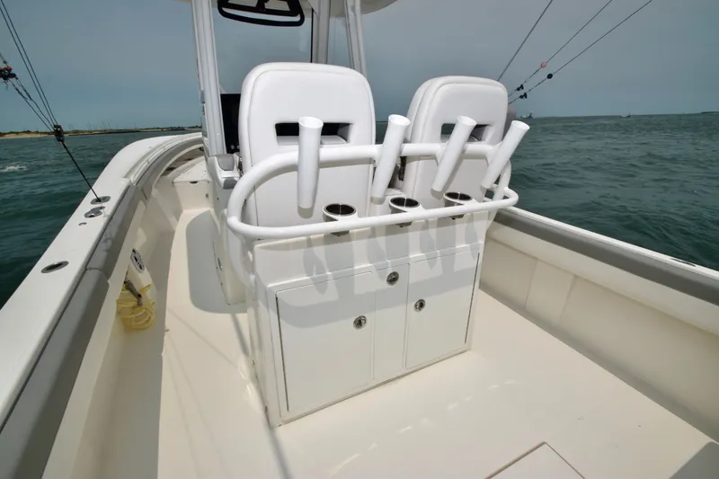 Slide: The Image of The image shows the cockpit of a 2023 Regulator 28 Forward Seating boat with white seats. - 37