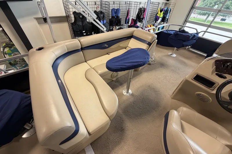 Slide: The Image of Interior of a 2010 Bennington 20SFi boat with beige and blue seating. - 14