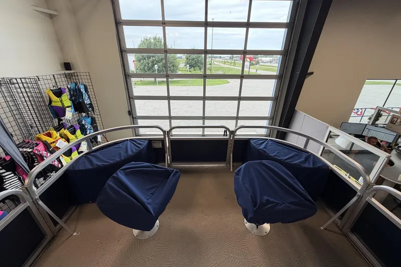 Slide: The Image of Interior of a 2010 Bennington 20SFi boat with blue seating and life jackets displayed. - 19
