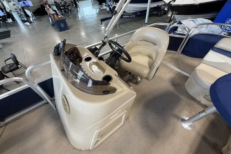 Slide: The Image of 2010 Bennington 20SFi boat interior with steering console and seating in showroom. - 11