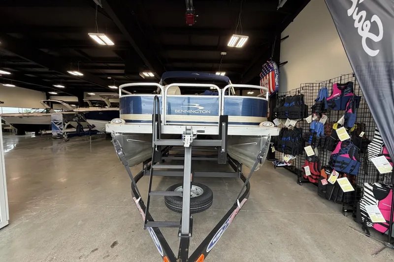 Slide: The Image of 2010 Bennington 20SFi pontoon boat displayed in showroom with life jackets. - 8
