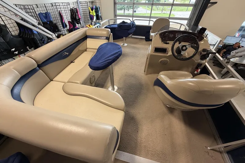 Slide: The Image of Interior of a 2010 Bennington 20SFi pontoon boat with beige and blue seating. - 10