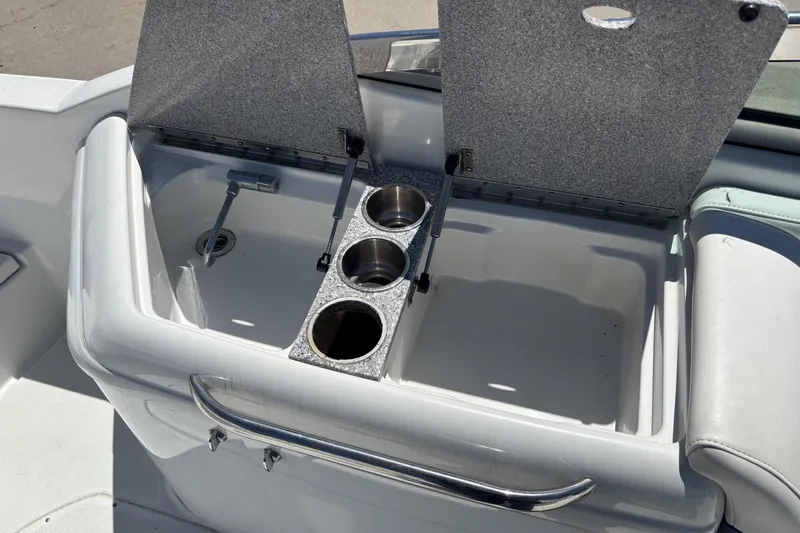 Slide: The Image of Open storage compartment with cup holders on a 2007 Formula 280 Bowrider boat. - 12