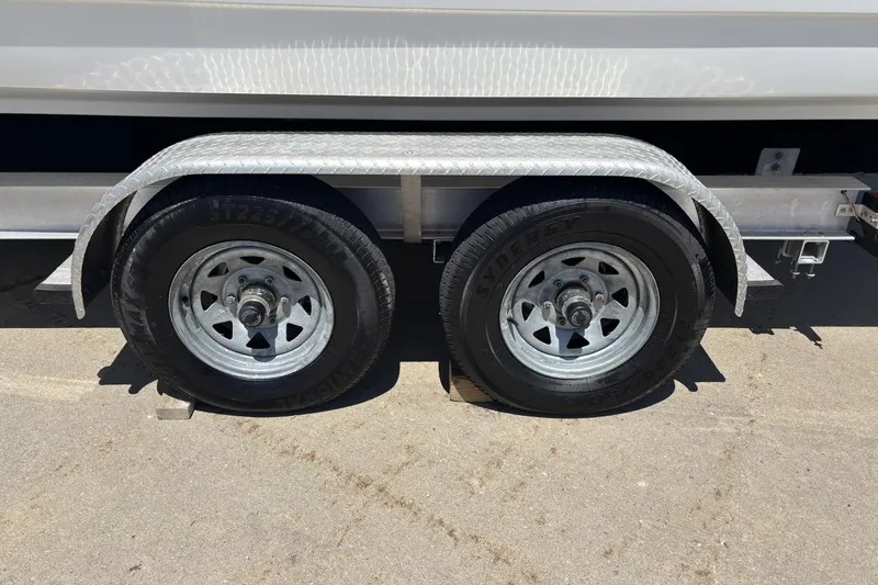 Slide: The Image of Trailer wheels for 2007 Formula 280 Bowrider boat on pavement. - 7