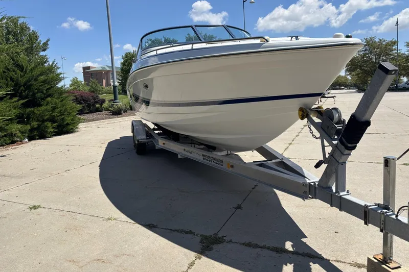 Slide: The Image of 2007 Formula 280 Bowrider boat on trailer, parked outdoors under a clear sky. - 3
