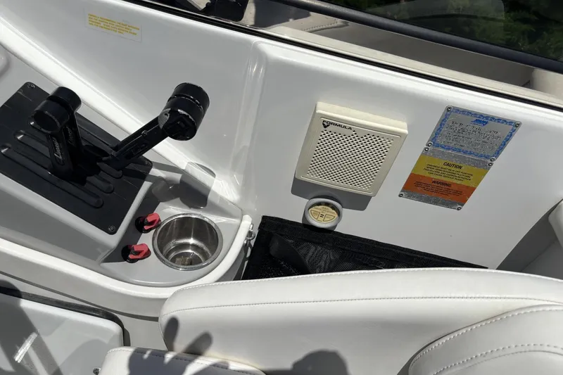 Slide: The Image of Control panel of a 2007 Formula 280 Bowrider boat with throttle and speaker. - 16