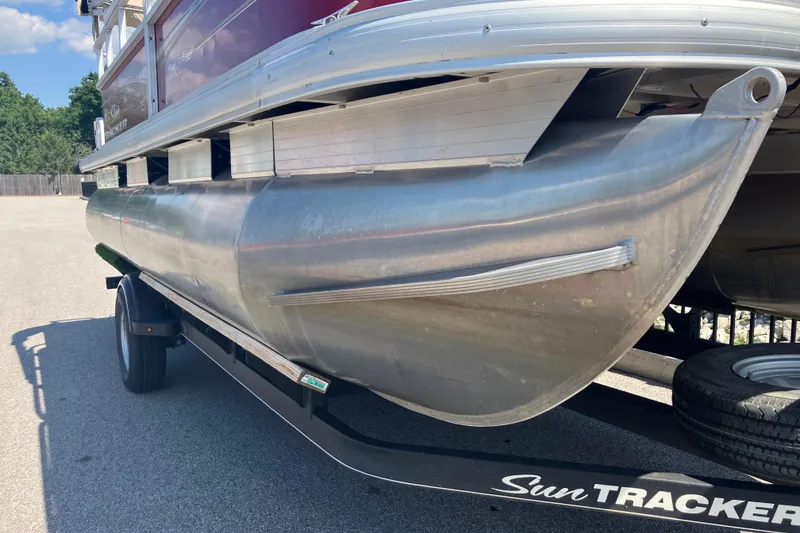 Slide: The Image of 2020 Sun Tracker Bass Buggy 18 DLX pontoon boat on trailer, side view. - 6