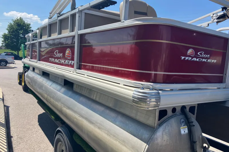 Slide: The Image of 2020 Sun Tracker Bass Buggy 18 DLX pontoon boat in parking lot. - 2